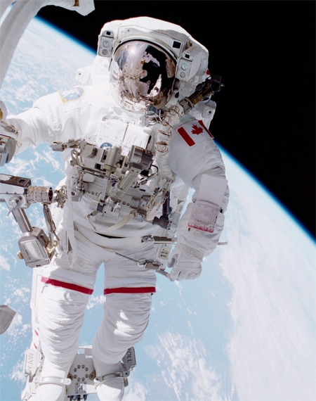 Canadian Space Agency Astronaut Chris Hadfield stands on a restraint connected to Canadarm on space shuttle Endeavour during one of two spacewalks of mission STS-100 in 2001. (NASA)