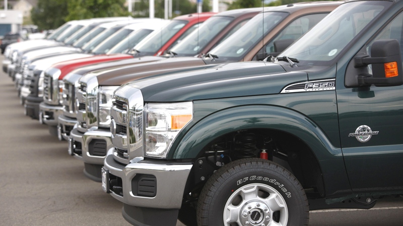 Unsold 2011 Ford F-350 pickup trucks sit at a dealership in the west Denver suburb of Lakewood, Colo. on June 27, 2010. (AP / David Zalubowski)