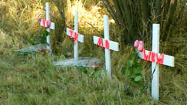 Four crosses placed at the site of a collision that killed four teenage boys near Grande Prairie.