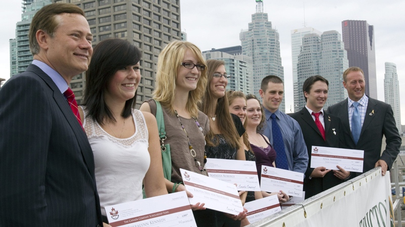 Canada Company founder Blake Goldring (left) and Defence Minister Peter Mackay (right) pose with Canada Company scholarship recipients (left to right) Sheralynn Kennedy; Kirsten Hess Von Kruedener; Natasha Roberge; Myriam Mercier; Jocelyn Ranger; Robert Girouard and Adam Naismith following the presentation of the scholarship on HMCS Fredericton in Toronto on Friday September 3, 2010. (THE CANADIAN PRESS/Frank Gunn)