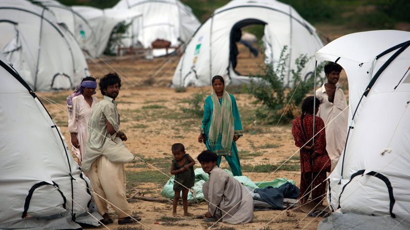 Pakistani flood survivors hang out outside their temporary tent shelters in Makli, Sindh province, Southern Pakistan, Saturday, Sept. 4, 2010. (AP / Vincent Thian)