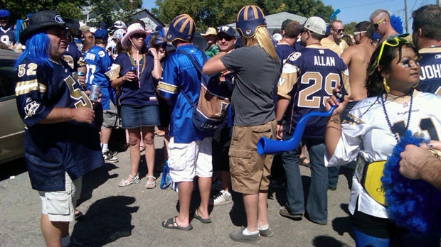 Bombers fans stand outside Mosaic Stadium Sunday before the Roughriders and Bombers play.