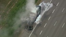 A smoking garbage truck is seen on the northbound lanes  of Hwy 400 on Monday, Sept. 3, 2012.
