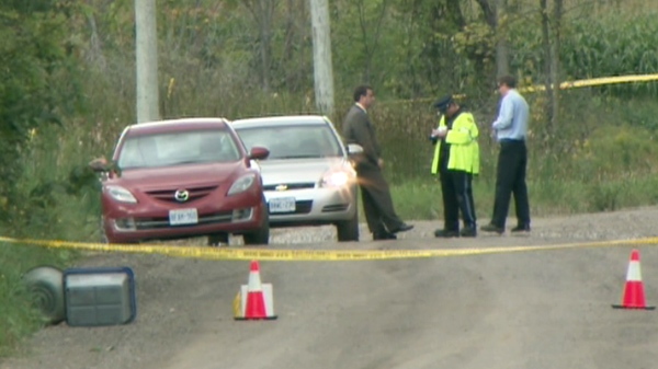 OPP investigators survey the scene where human remains were found about 12 kilometres from Orangeville, Ont. on Sunday, Sept. 5, 2010.
