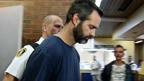 David Folker is led into court in St. John's, N.L. Tuesday Sept. 7, 2010. The 39 year-old was arrested in connection with the death of Anne Marie Shirran, whose body was found last Thursday near the community of Cappahayden. 