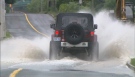 A Jeep drives through a flooded section of Pottery Road after heavy rains on Tuesday, Sept. 4, 2012.