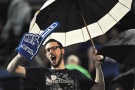 File photo: A spectator enjoys the game under the shelter of his umbrella after the retractable roof of the Rogers Centre got stuck open in a rain storm during the sixth inning of the Toronto Blue Jays game in Toronto, Tuesday, September 4, 2012. THE CANADIAN PRESS/Aaron Vincent Elkaim