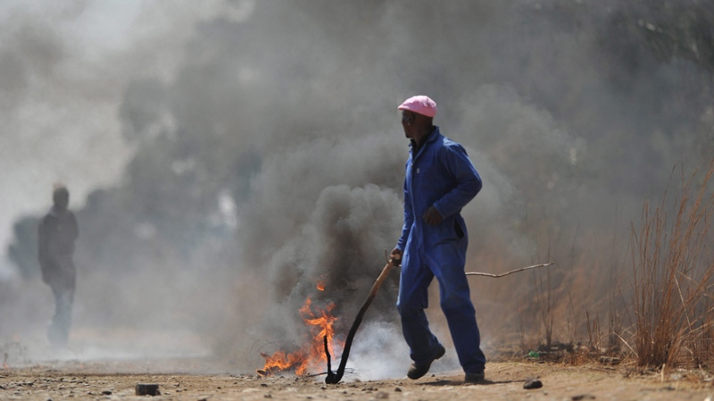 Miners set up a barricade at Gold One International's mine east of Johannesburg. on Sept. 3, 2012.
