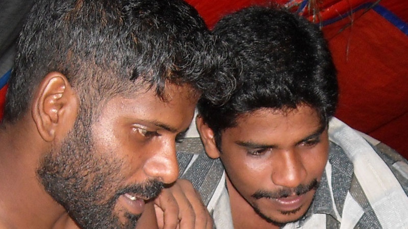 This undated photo shows Sanjeev Kuhendrarajah (left) and an unidentified man while they were aboard the Jaya Lestari 5. (Photo courtesy of Sanjeev Kuhendrarajah