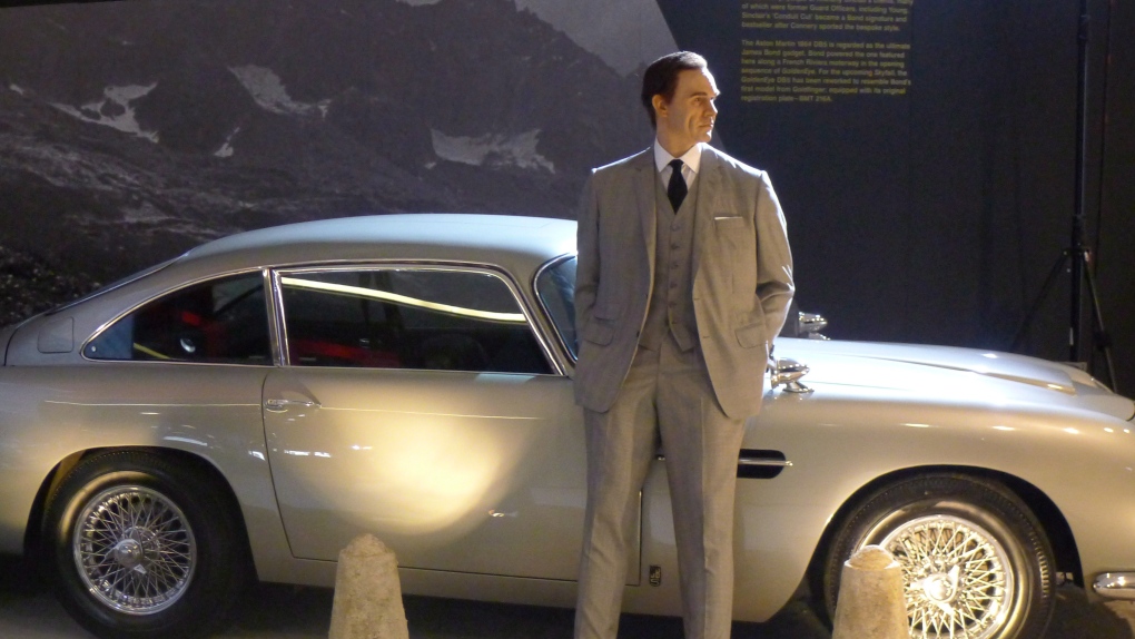James Bond and his iconic Aston Martin man the way to the entrance of “Designing 007: Fifty Years of
