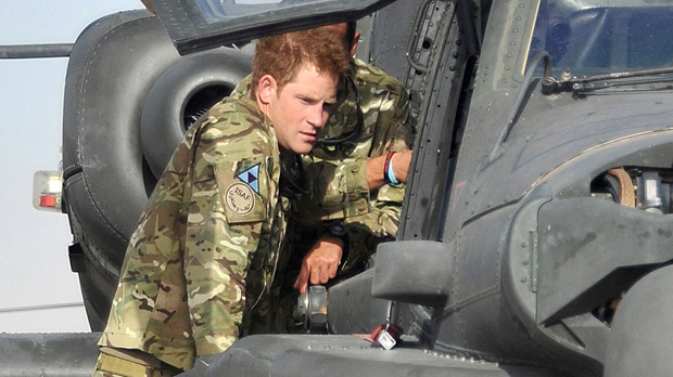 Prince Harry is shown an Apache helicopter by a member of his squadron, obscured behind, at Camp Bastion in Afghanistan on Friday, Sept. 7, 2012. (Cpl. Paul Morrison / Army Photographer, MOD)