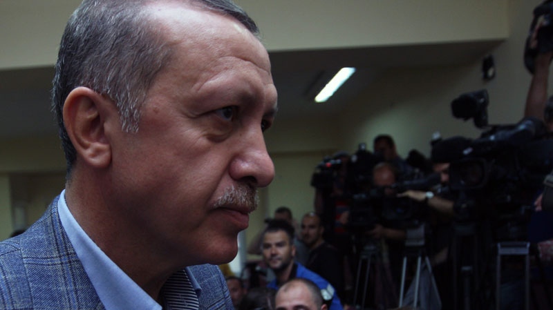 Turkish Prime Minister Recep Tayyip Erdogan addresses the media at a polling station after he cast his vote in a referendum on changes to the constitution that was crafted in the wake of Turkey's 1980 military coup, in Istanbul, Turkey, Sunday, Sept. 12, 2010. (AP / Burhan Ozbilici)