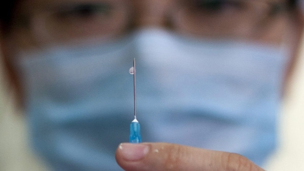 A nurse prepares a vaccine shot against measles at a clinic in Beijing, China, Saturday, Sept. 11, 2010. (AP Photo/Alexander F. Yuan)