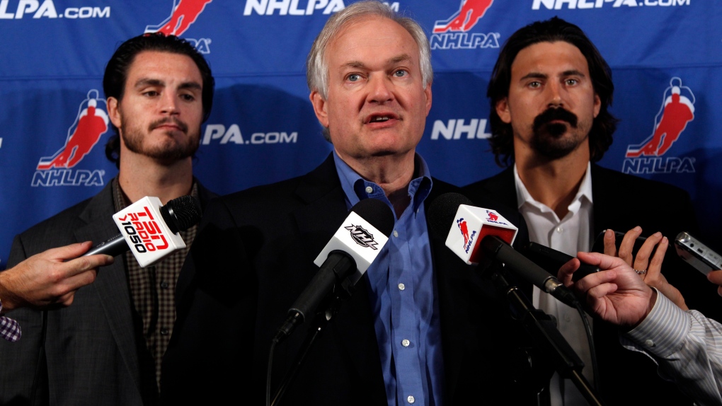 NHL Players Association executive director Donald Fehr, center, is joined by players Kevin Westgath,