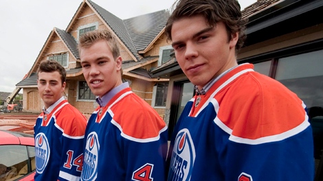 Jordan Eberle, left, Taylor Hall, centre, and Magnus Paajarvi pose in front of a show home that will be won by a lucky lottery winner, with the proceeds going to the Edmonton Oilers Community Foundation charity, after an Edmonton Oilers press conference on Wednesday, September 8, 2010. THE CANADIAN PRESS/John Ulan