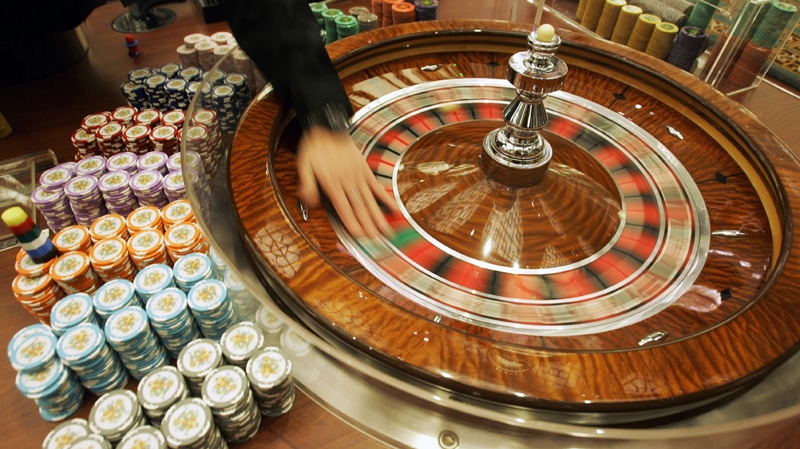 A staff member demonstrates the roulette wheel at Grand Lisboa Casino in Macau on Feb. 11, 2007.