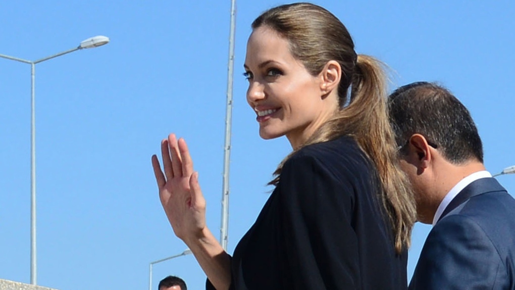 United Nations High Commissioner for Refugees (UNHCR) special envoy Angelina Jolie waves as she arri