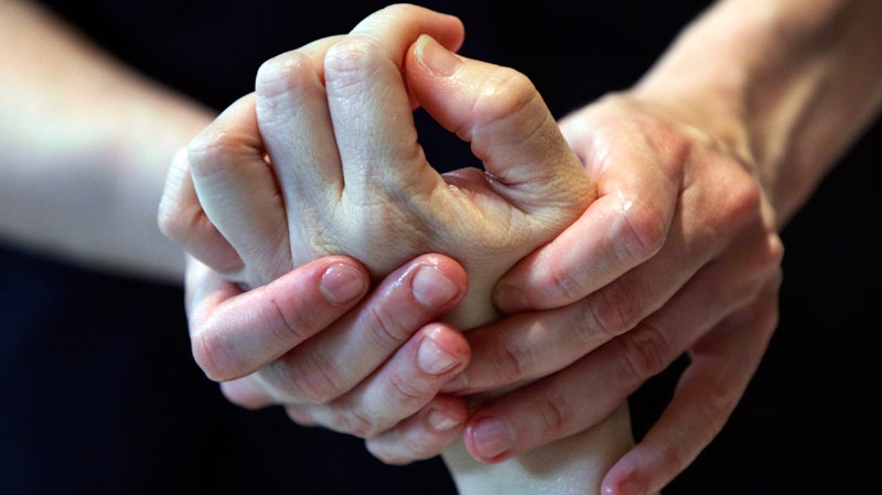 A woman receives a hand massage. (AP Photo/Richard Drew)