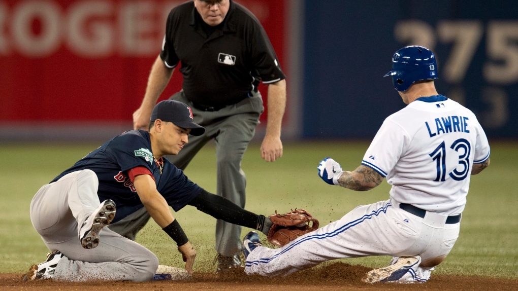 Toronto Blue Jays' Brett Lawrie is tagged at second base by Boston Red Sox short stop Jose Iglesias