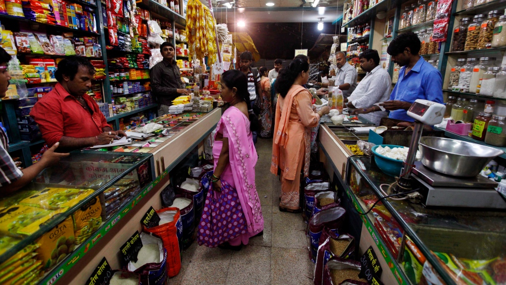Indian people shop at a store in Mumbai, India, Friday, Sept. 14, 2012. India agreed Friday to open 