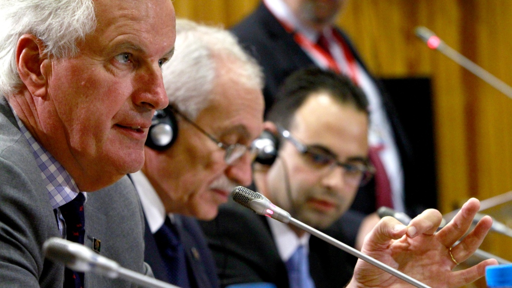 European Commissioner for Internal Market and Services Michel Barnier, left, addresses the media dur