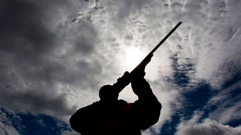 A rifle owner checks the sight of his rifle at a hunting camp property in rural Ontario west of Ottawa on Wednesday Sept. 15, 2010. (Sean Kilpatrick / THE CANADIAN PRESS)