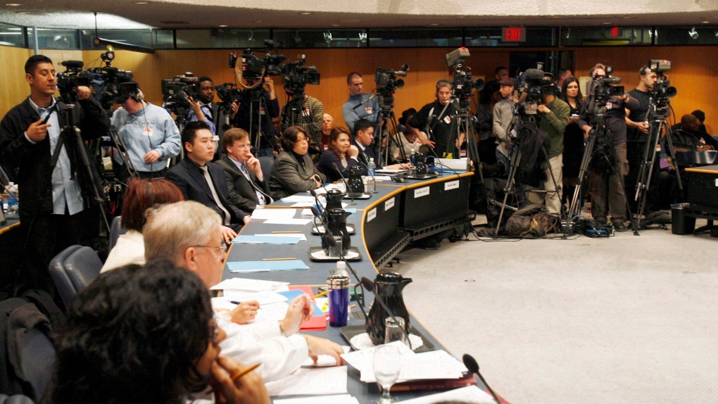 Reporters and camera operators jam a board meeting of the Toronto District School Board Chair during