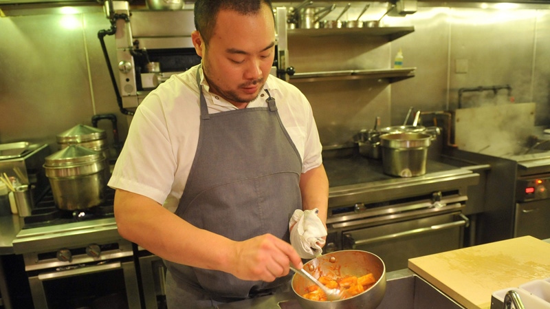 Chef David Chang prepares roasted rice cakes in this Nov. 10, 2011 file photo.