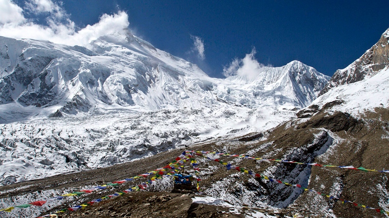 Prayer flags fly at the Manaslu base camp in Nepal on Oct. 18, 2011.
