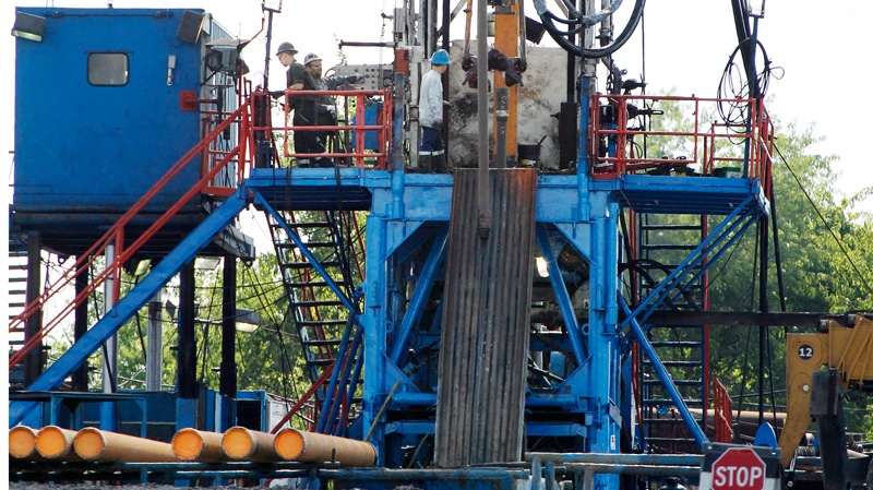 A crew works on a shale-based natural gas drilling rig in Zelienople, Pa. on June 25, 2012.