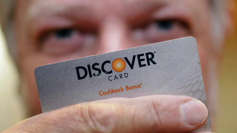 Steve Wheelock holds up his Discover Card in San Francisco on June 22, 2011.