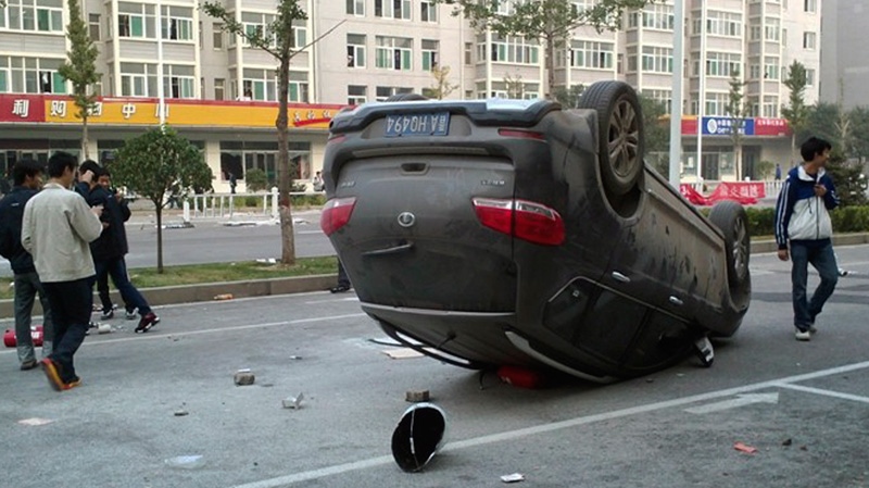 A car overturned during a brawl by Foxconn employees in Taiyuan on Sept. 24, 2012.