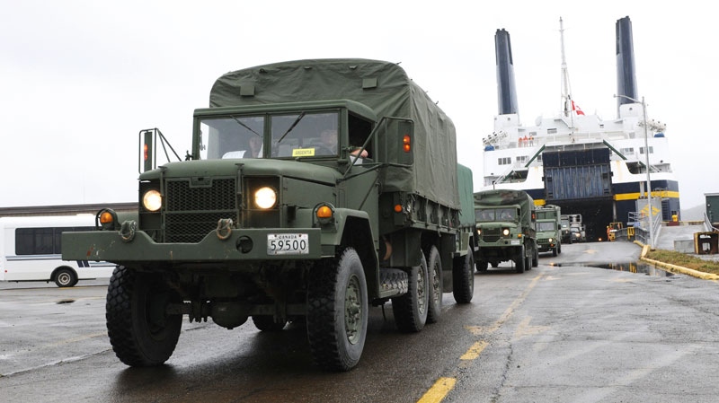 A convoy of military vehicles flow off the Joseph and Clara Smallwood ferry at Argentia Newfoundland on Saturday Sept. 25, 2010. (DND-HO-WO Jerry Kean / THE CANADIAN PRESS)