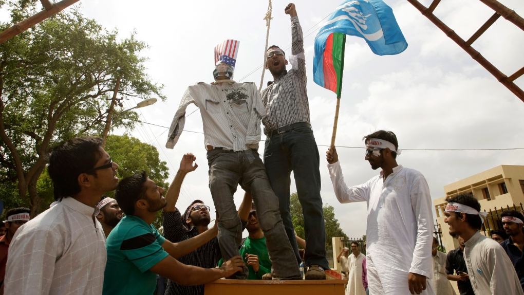 Pakistani students hang an effigy of U.S. pastor Terry Jones at a rally