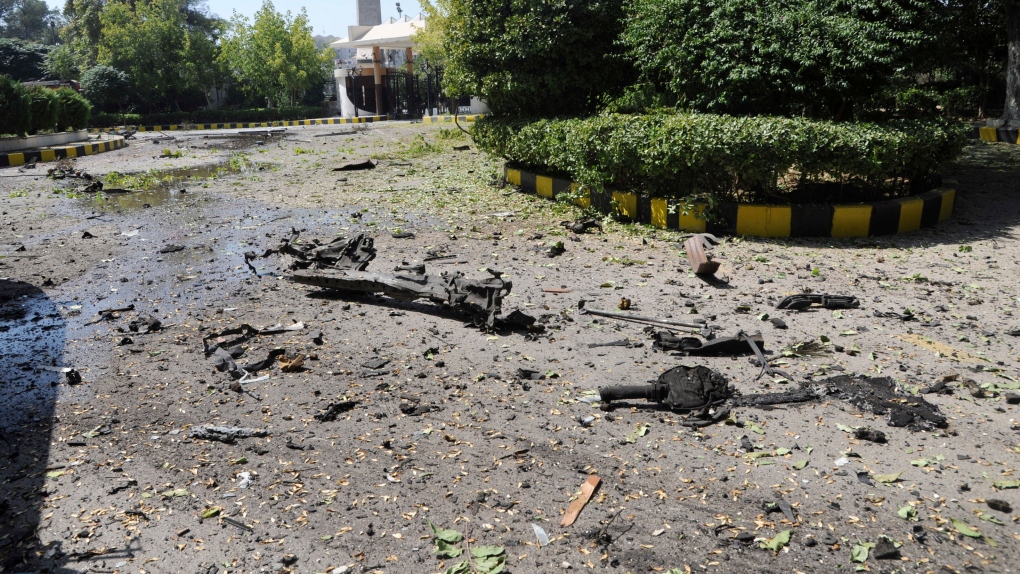 The remains of a vehicle and other debris are shown where they landed after a car exploded