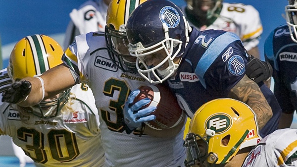 Toronto Argonauts Chad Owen is tackled by Edmonton Eskimos Calvin McCarty, left, in CFL action at Moncton Stadium in Moncton, N.B. on Sunday, Sept. 26, 2010.THE CANADIAN PRESS/Andrew Vaughan