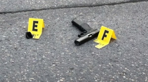 Evidence markers surround a gun found near Stafford and Hector following the shooting on Thursday.

