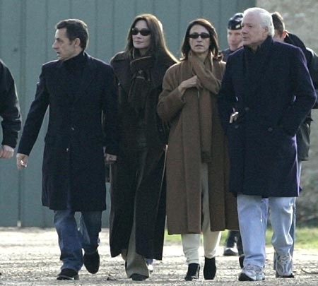 France's President Nicolas Sarkozy, left, and his new wife, former Italian model Carla Bruni, second left, walk in the park of the Chateau de Versailles, near the Lanterne, an official residence in Versailles, Sunday, Feb. 3, 2008. As the couple strolled in Versailles on Sunday they were accompanied by Italian businessman Maurizio Remmert, right, who has reportedly claimed to be Bruni's biological father from an affair he had long ago with her mother, concert pianist Marysa Borini. At second right is Remmert's wife Marcia de Luca. (AP Photo/Thibault Camus)  