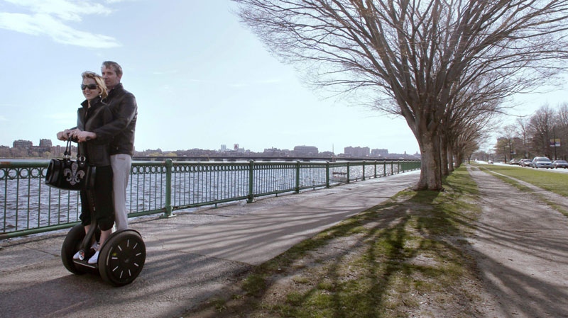 A couple rides a Segway along the banks of the Charles River in Cambridge, Mass., Monday, April 5, 2010. (AP Photo/Charles Krupa)