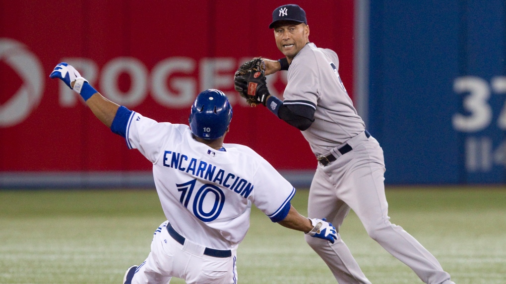Toronto Blue Jays Edwin Encarnacion (left) is forced out at second base by New York Yankees short st