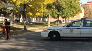 Police officers investigate at Maryland Street and Wellington Avenue in Winnipeg on Sept. 29. 