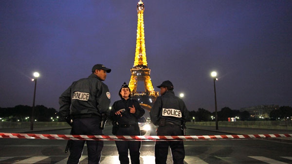 Policemen officers stand by the Eiffel Tower, in Paris, Tuesday Sept. 18, 2010. (AP / Thibault Camus)