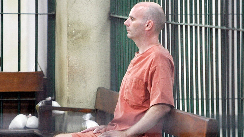 Canadian Christopher Paul Neil sits in the cell at criminal court in Bangkok, Thailand Friday, Aug. 15, 2008. (AP / Sakchai Lalit)