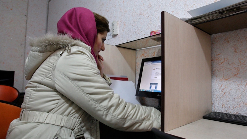 An Iranian woman uses a computer in a Tehran internet cafe on Feb. 13, 2012.