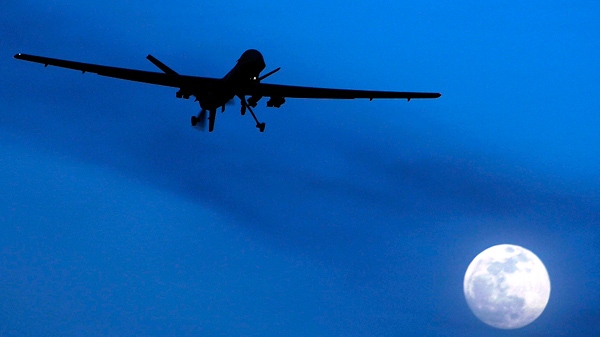 A U.S. Predator drone flies over the moon above Kandahar Air Field, southern Afghanistan on Jan. 31, 2010. (AP / Kirsty Wigglesworth)