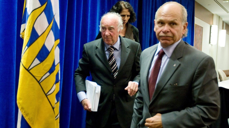 Retired judge Thomas Braidwood, left, and Braidwood Commission counsel Art Vertlieb leave following a news conference regarding phase one of his inquiry into the use of tasers by police in British Columbia, in Vancouver, B.C., on Thursday July 23, 2009. (THE CANADIAN PRESS/Darryl Dyck)