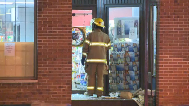 firefighter in the doorway of a Montreal depanneur