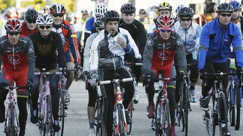 Actor Patrick Dempsey, center, begins biking in the second annual Dempsey Challenge, Sunday Oct. 3, 2010 in Lewiston, Maine. (AP Photo / Joel Page)