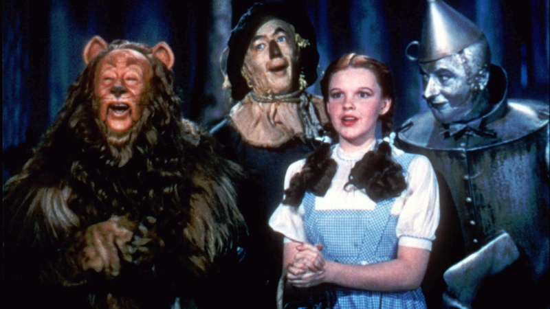 In this undated file photo released by Warner Bros., Bert Lahr as the Cowardly Lion, Ray Bolger as the Scarecrow, Judy Garland as Dorothy, and Jack Haley as the Tin Woodman, sing in this scene from 'The Wizard of Oz,' distributed by Warner Bros. (AP / Warner Bros.)