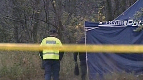 A police tent covers human remains found behind a gas station near Brockville, Wednesday, Oct. 6, 2010.